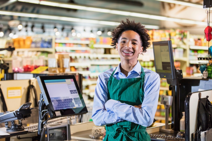 Teenager Working on a Register Whilst in College