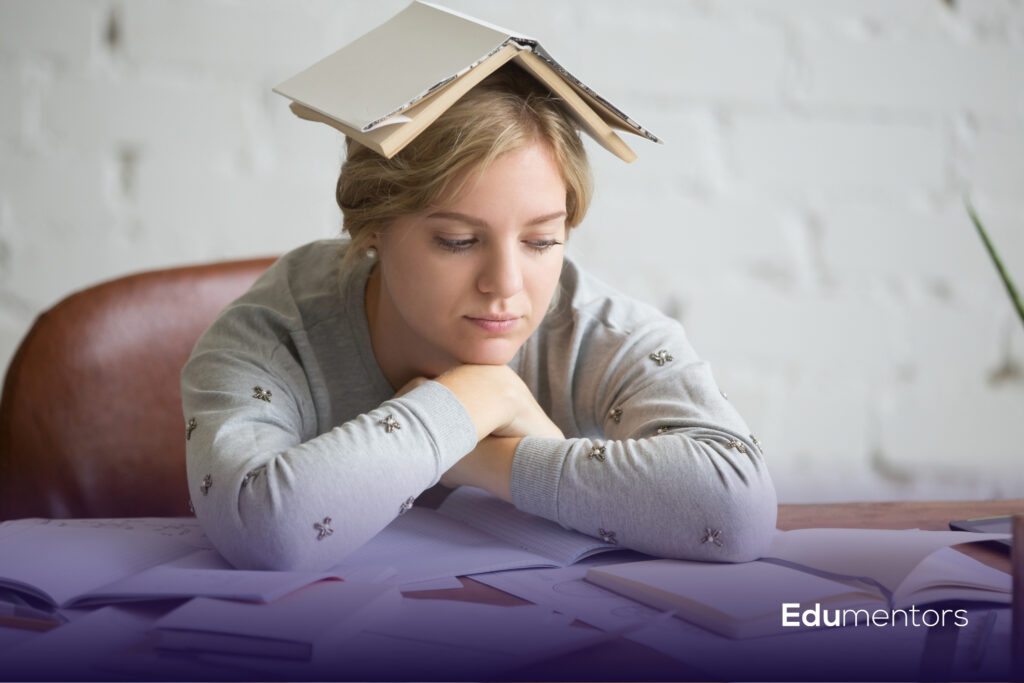 Student sitting at a desk with books and revision notes while preparing for GCSE mock exams.