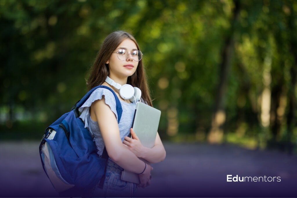 A Levels student with a backpack, headphones and laptop during sixth form study