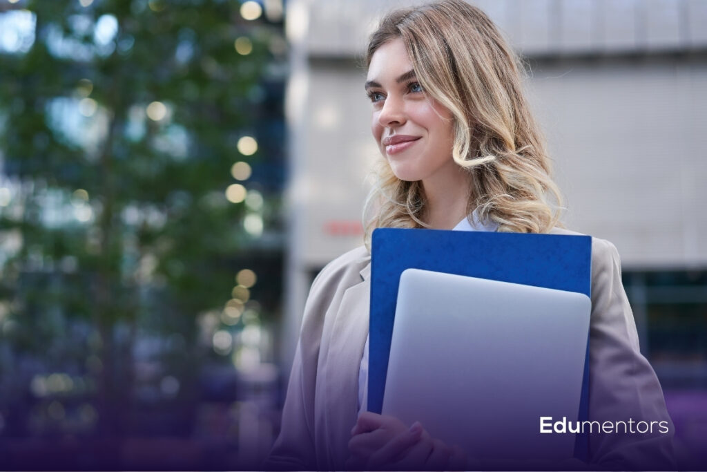 A Levels student carrying a laptop and study folder while preparing for her courses