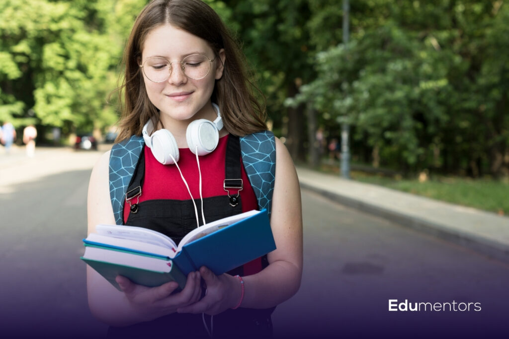 GCSE student reading revision books while preparing for subjects and exams