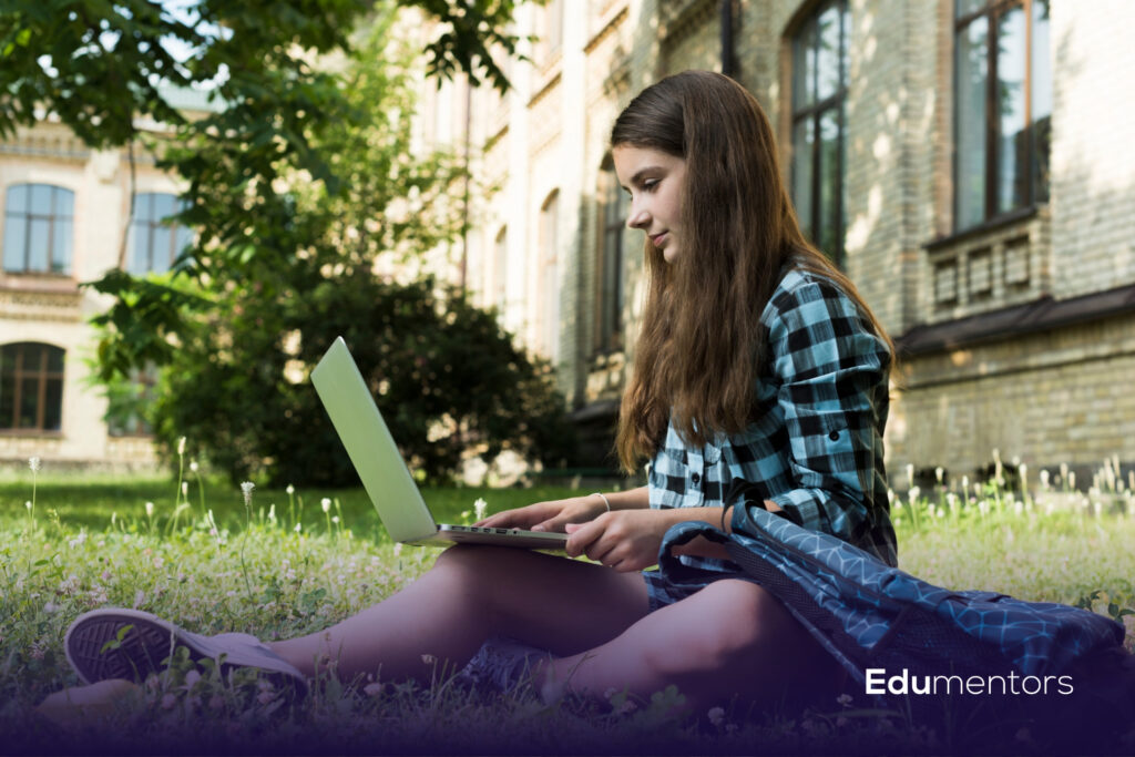 Student using a laptop outdoors, illustrating Arden University online courses and flexible study.