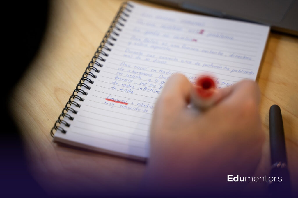 Student writing revision notes to prepare for Year 10 mock exams past papers and GCSE assessments.